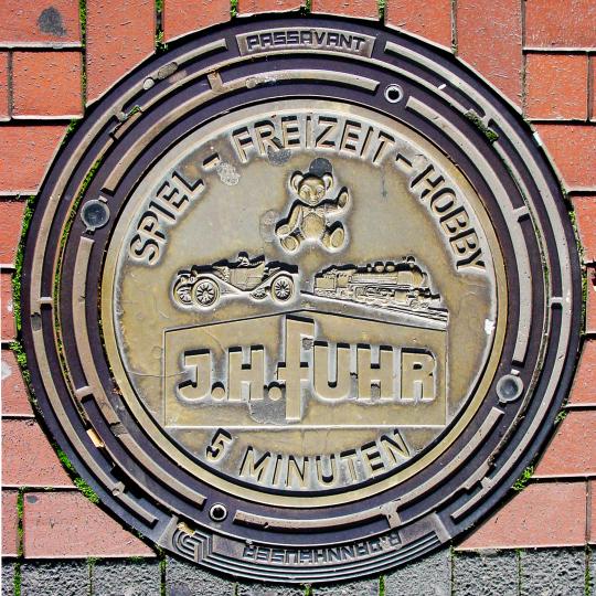J. H. Fuhr Ad on Manhole Cover